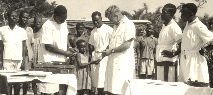 An outdoor clinic, probably Itu Nigeria. Showing patients being treated by missionary Dr Stanley Brown .png